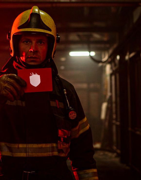 A firefighter holding a red TS Patch TS-25 sticker